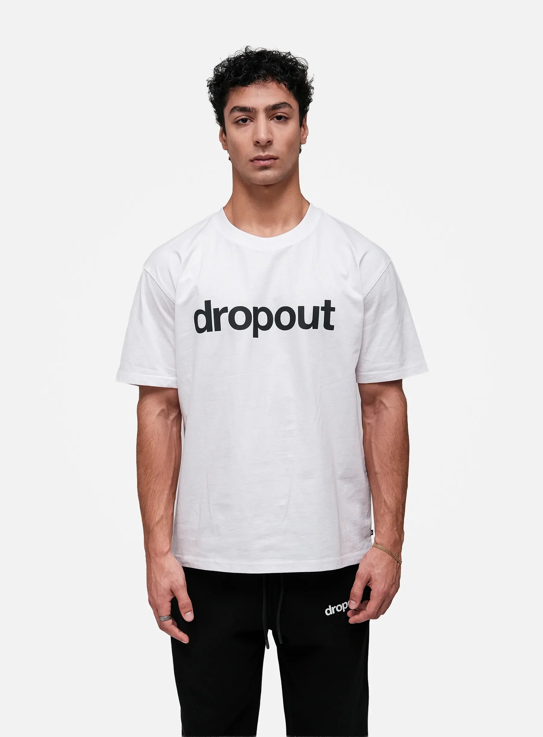 Person wearing a white t-shirt with 'dropout' text on a white background