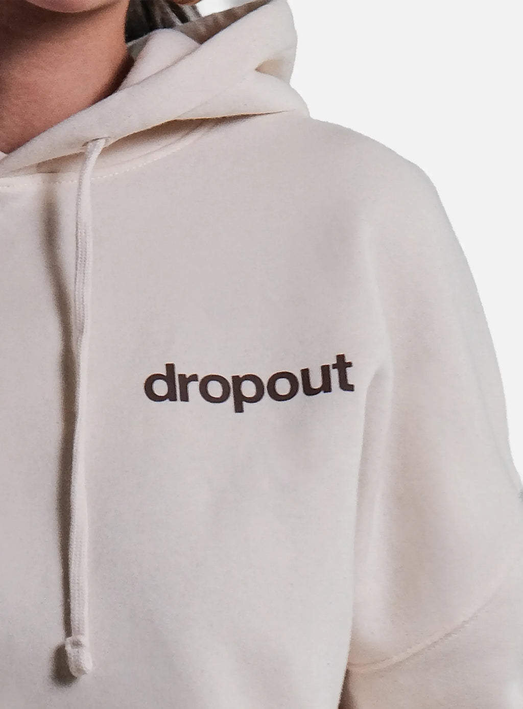 Beige hoodie with 'dropout' text on a white background