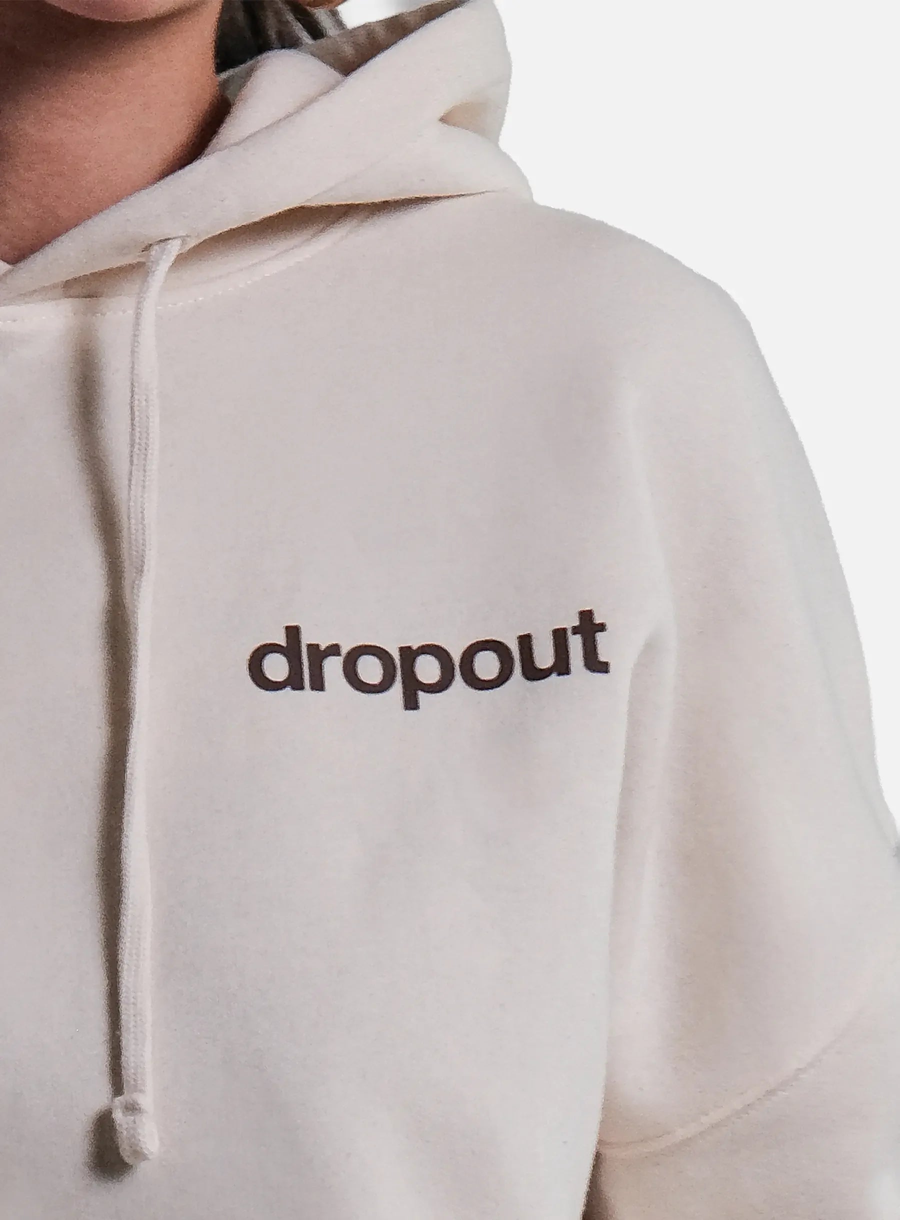 Beige hoodie with 'dropout' text on a white background