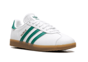 White Adidas sneaker with green stripes on a white background