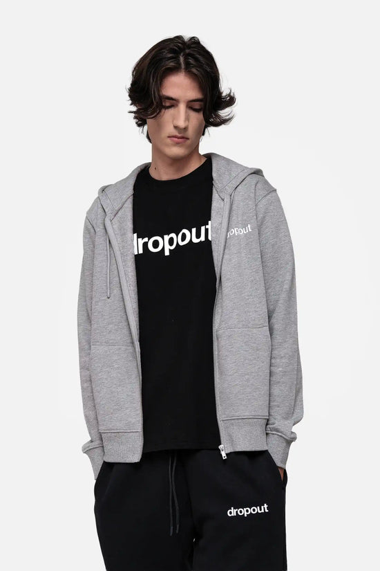 Person wearing a grey hoodie and black t-shirt with 'dropout' branding on a white background