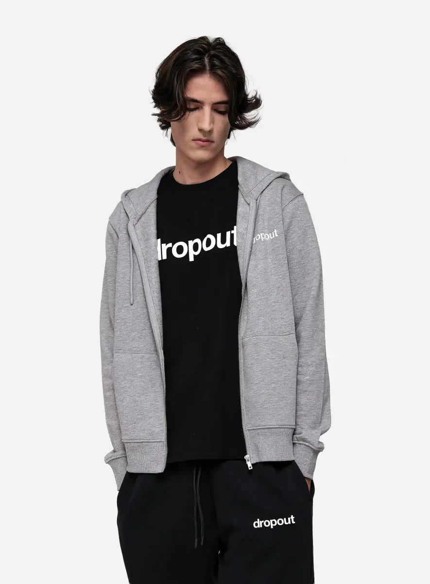 Person wearing a grey hoodie and black t-shirt with 'dropout' branding on a white background