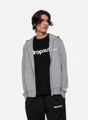 Person wearing a grey hoodie, black t-shirt, and black pants with 'dropout' branding on a light grey background