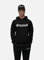Model in black dropout Milano hoodie, sweatpants, and cap, premium streetwear ensemble