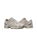 Beige mesh New Balance sneakers with chunky sole and textured streetwear design, side view
