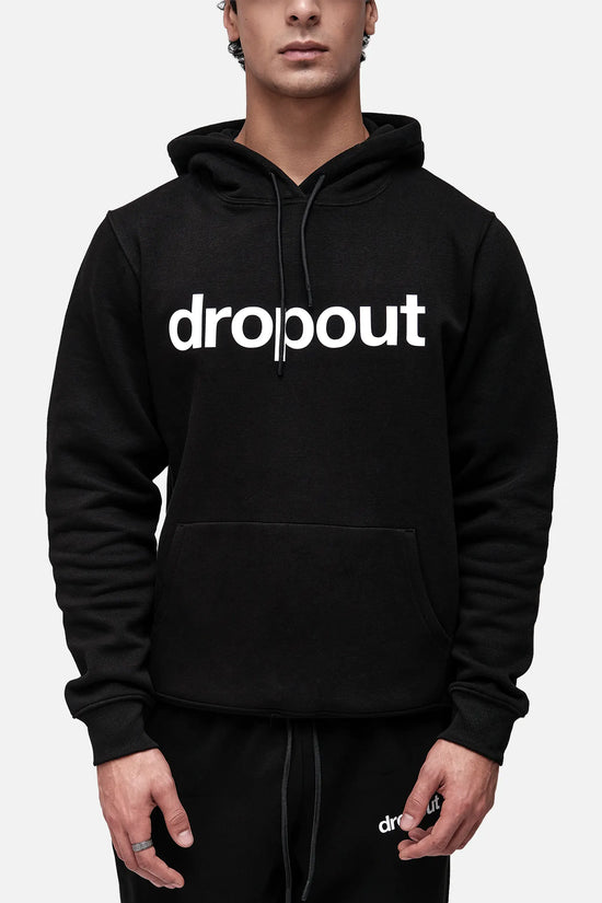 Person wearing a black hoodie with 'dropout' text on a white background