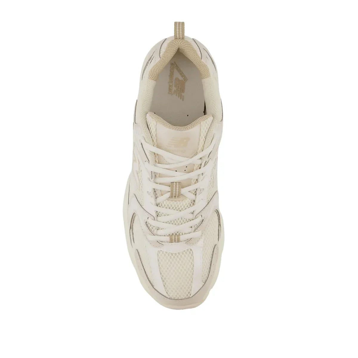 Top view of cream mesh and suede streetwear sneaker with laces, neutral background