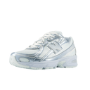 Silver and white New Balance sneaker with mesh and metallic accents, streetwear style