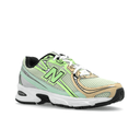 New Balance sneaker with beige, green, and black accents, mesh upper, white sole, streetwear style
