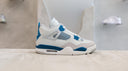 Side view of the Air Jordan 4 Retro Military Blue (2024) sneaker showcasing its light ivory and blue design.