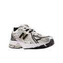 White running shoe with black and gold accents on a white background