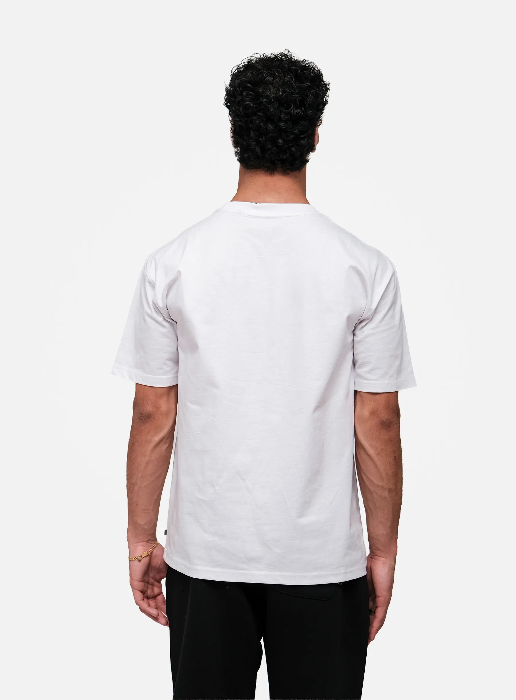 Person wearing a plain white t-shirt on a white background