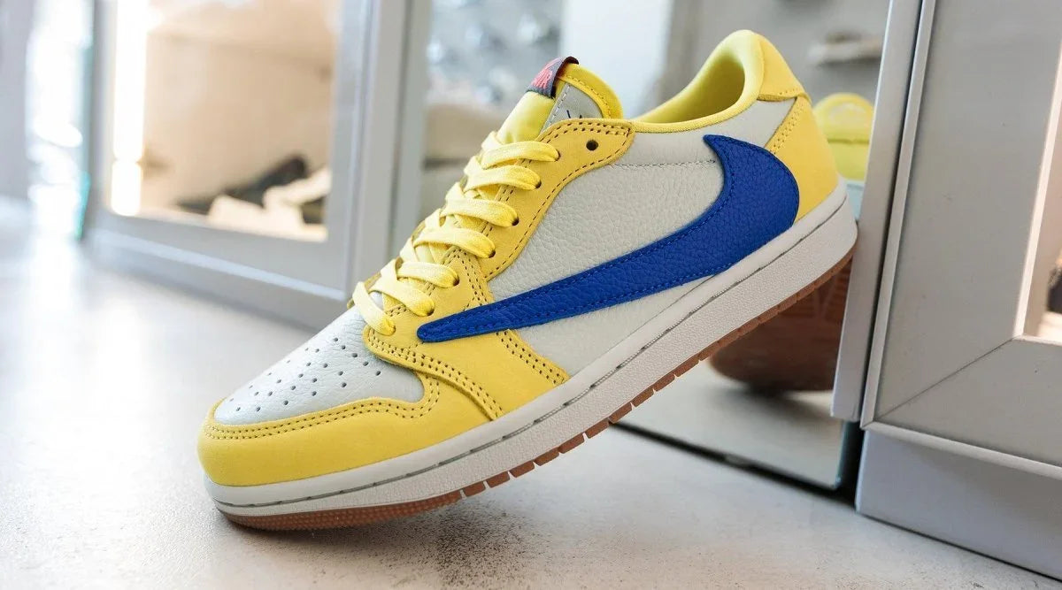 Yellow and white low-top sneaker with blue swoosh and gum sole on display in streetwear store