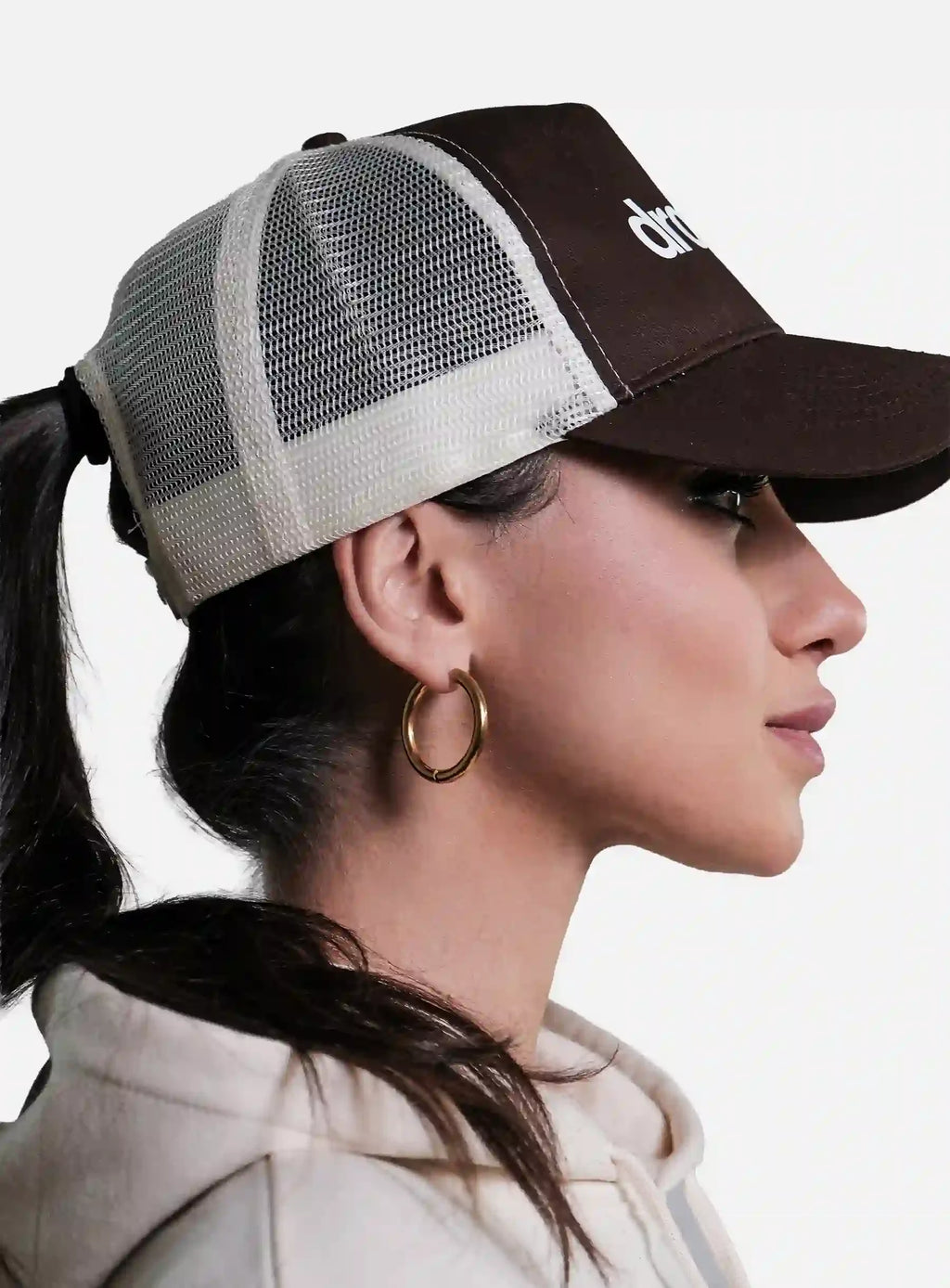 Woman wearing a Brown/Beige cap with 'Dr. Martens' logo, side view.