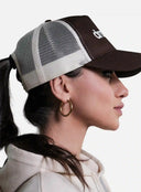 Woman wearing a Brown/Beige cap with 'Dr. Martens' logo, side view.