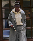Person wearing a Beige hoodie, and gray pants with 'dropout' branding.