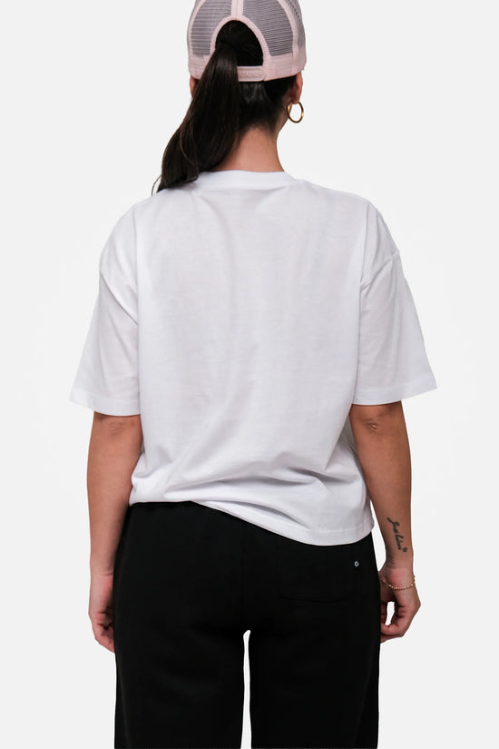 Person wearing a white t-shirt and black pants on a white background