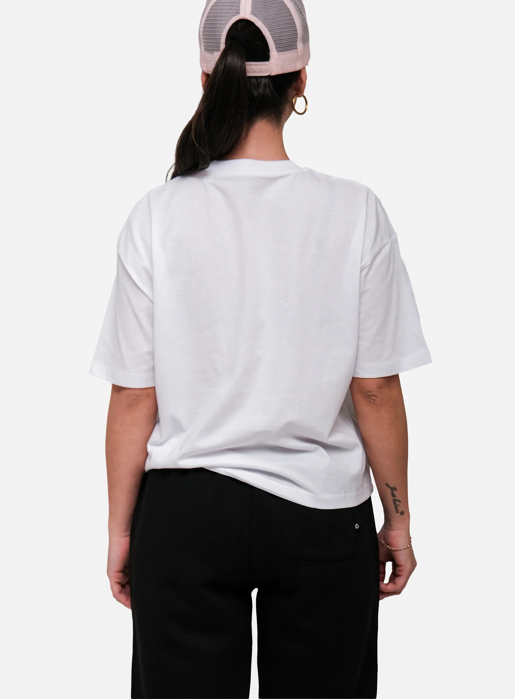 Person wearing a white t-shirt and black pants on a white background