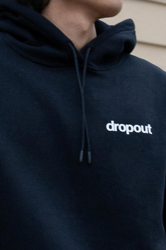 Navy hoodie with 'dropout' logo on a neutral background