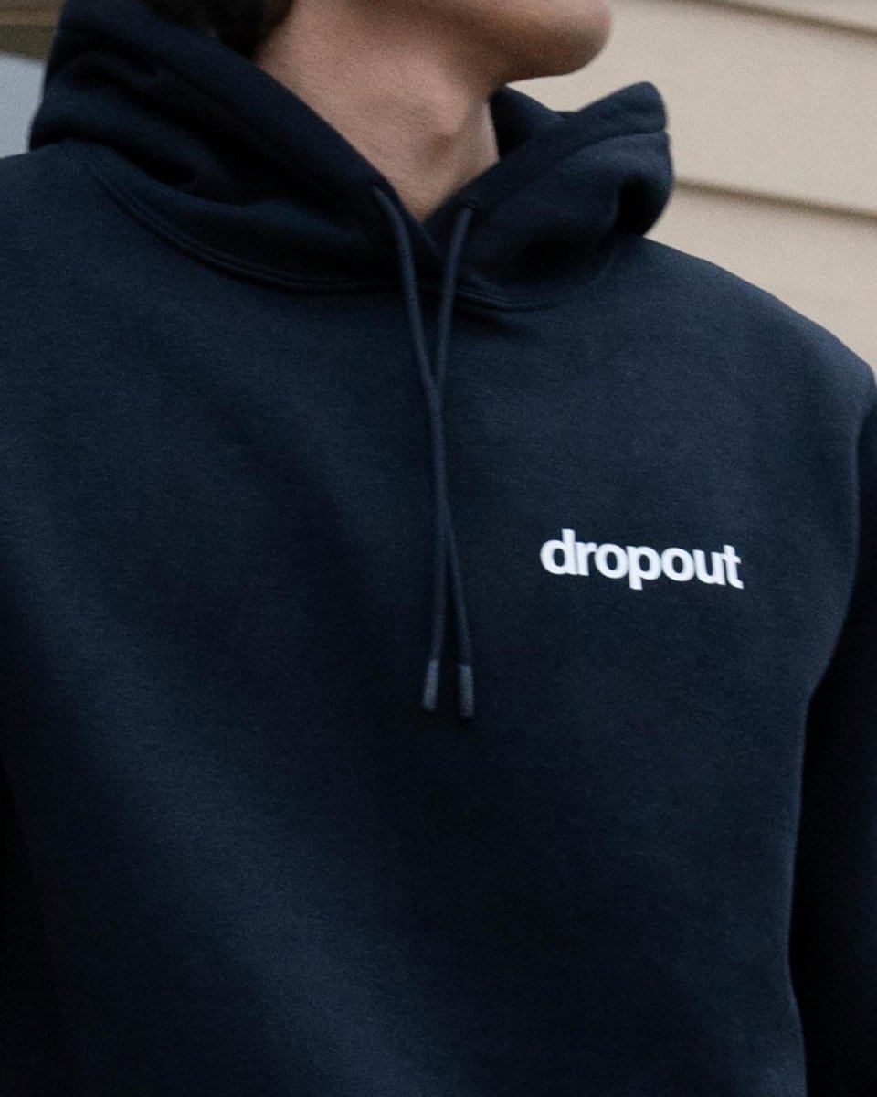 Navy hoodie with 'dropout' logo on a neutral background
