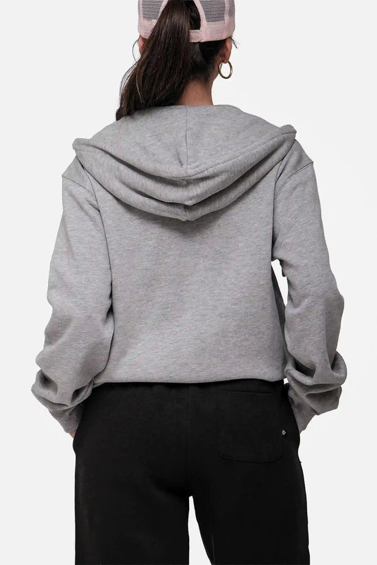 Person wearing a grey hoodie from behind on a white background