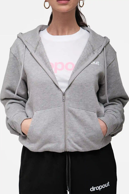 Person wearing a grey hoodie over a white shirt with 'dropout' branding.