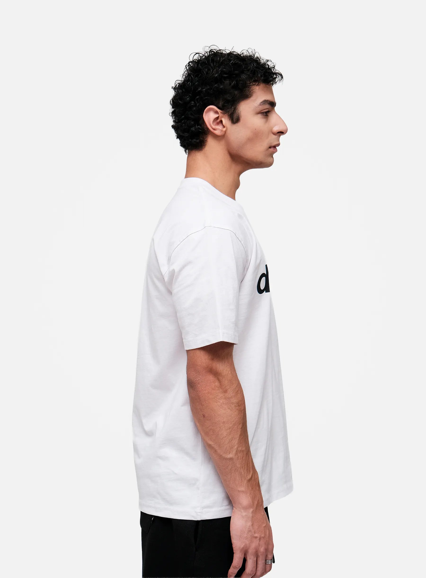 Person wearing a white t-shirt with a black logo on a white background
