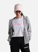 Person wearing a grey hoodie, white t-shirt, black pants, and pink cap with 'dropout' branding on a white background.