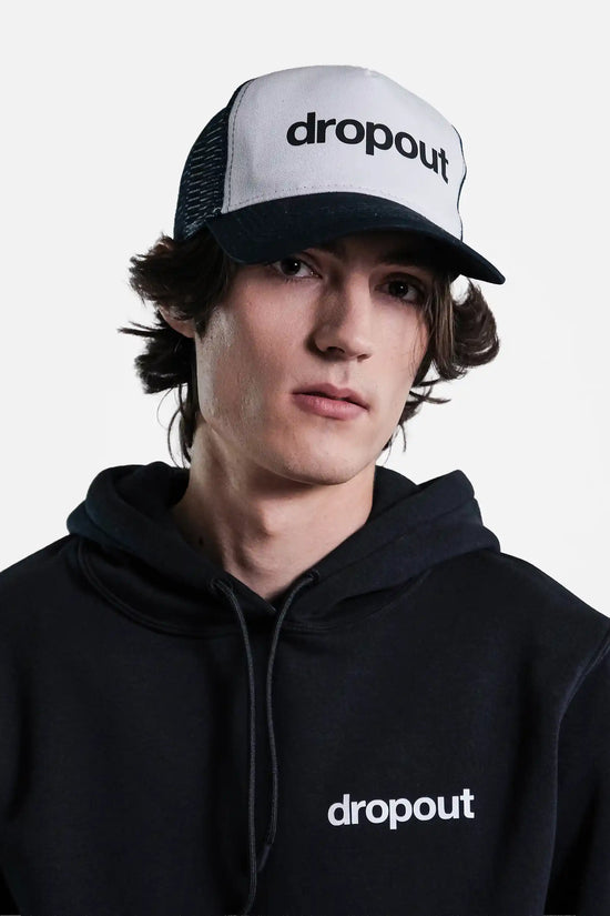 Person wearing a black hoodie and White/Navy cap with 'dropout' branding on a gray background