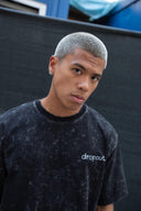 Model wearing faded black dropout pencil T-shirt, showcasing vintage street style with a relaxed fit.