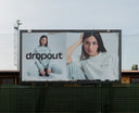 Billboard featuring a model in gray dropout apparel, highlighting modern streetwear style and fashion trends.