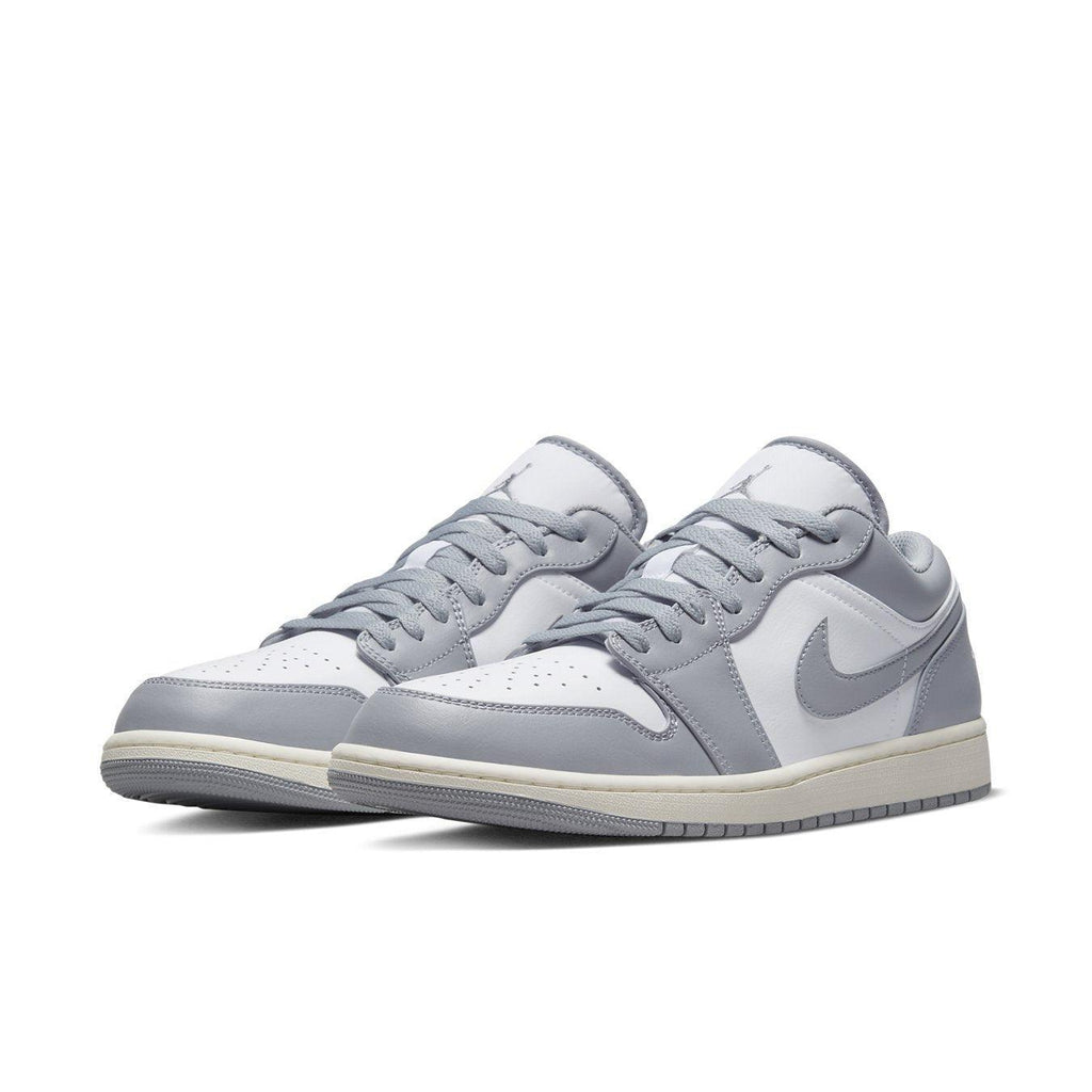 Air Jordan 1 Low Vintage Stealth Grey sneakers featuring white leather and grey overlays with aged midsole.