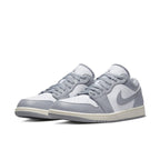 Air Jordan 1 Low Vintage Stealth Grey sneakers featuring white leather and grey overlays with aged midsole.