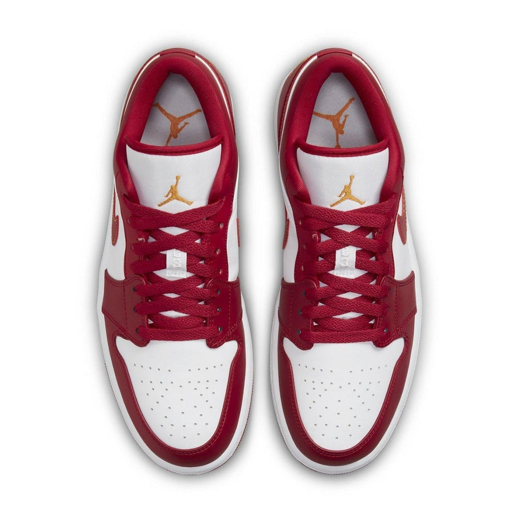 Air Jordan 1 Low Cardinal Red sneakers with white and red color blocks, featuring orange stitching and Jumpman logo.