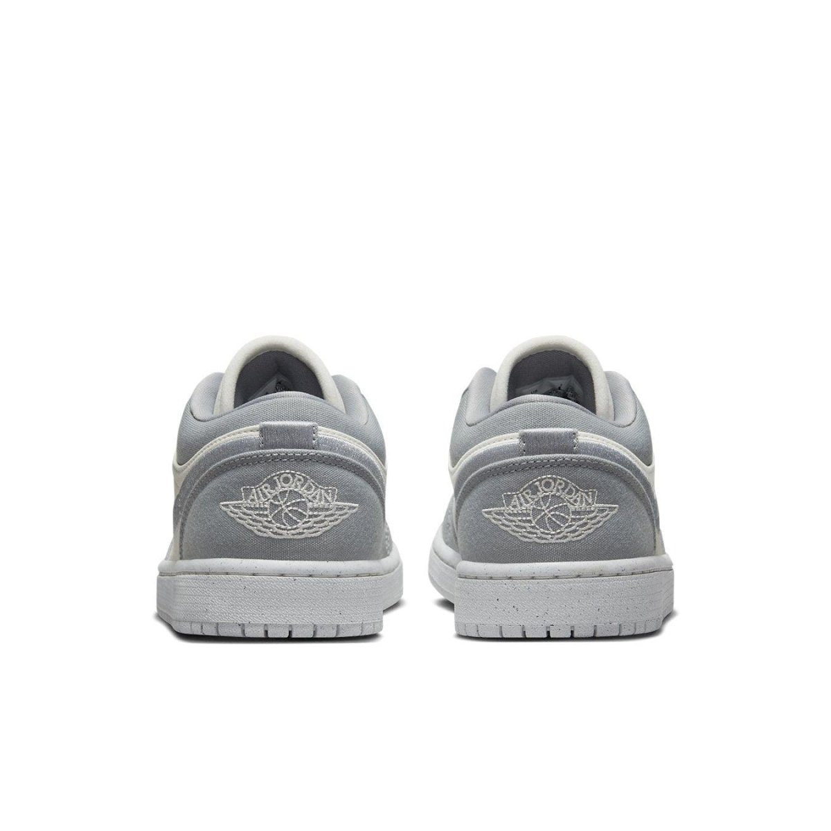 Back view of Air Jordan 1 Low SE Light Steel Grey women's sneakers showcasing embroidered logo and soft grey color.