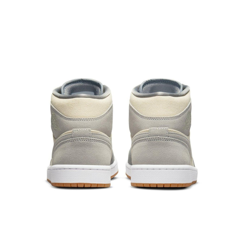 Rear view of Jordan 1 Mid SE Coconut Milk Particle Grey sneakers with suede and canvas upper.