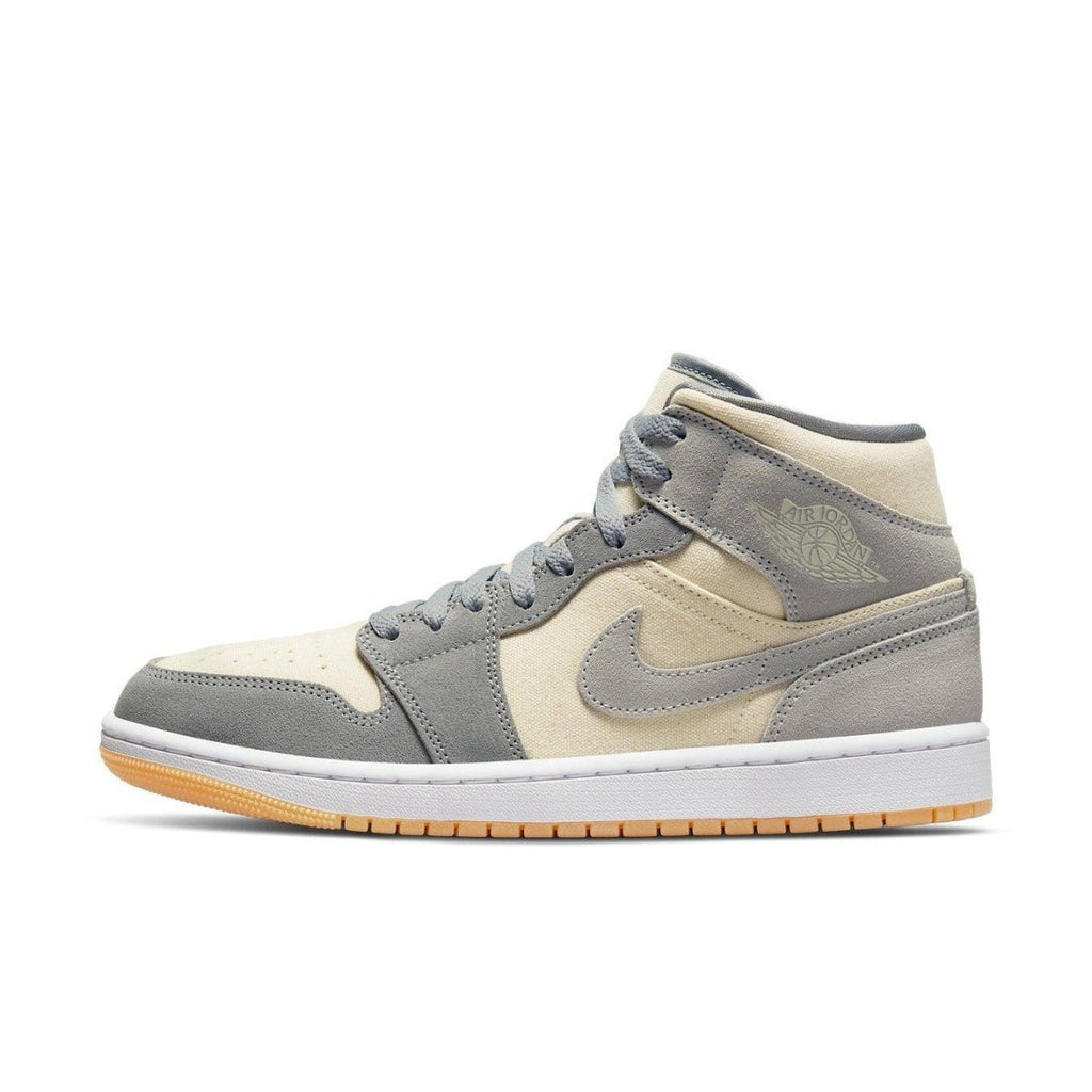 Jordan 1 Mid SE Coconut Milk Particle Grey sneaker featuring cream canvas upper and gray suede accents.