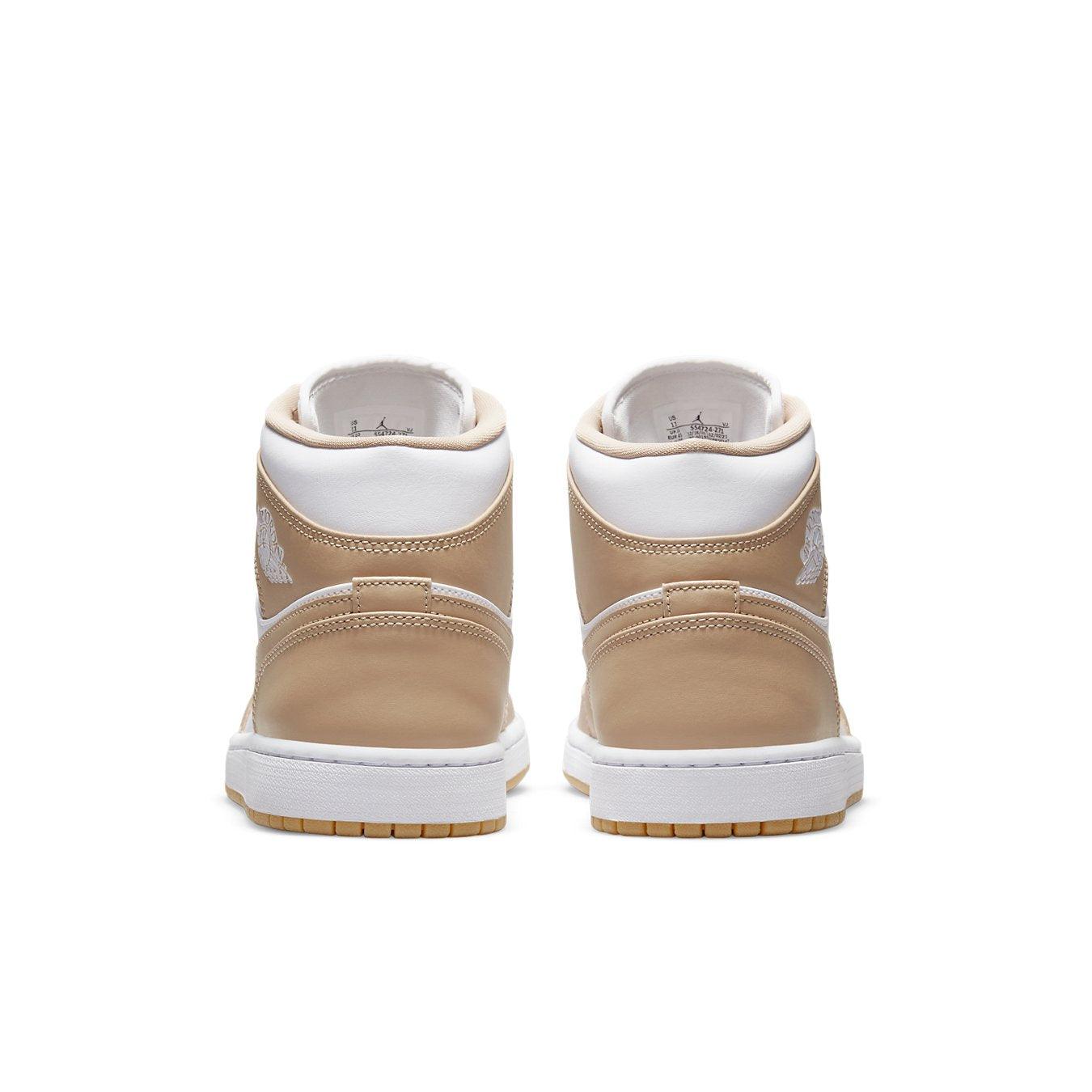 Jordan 1 Mid Tan Gum sneakers showcasing a premium tan and white design with a gum sole from the back view.