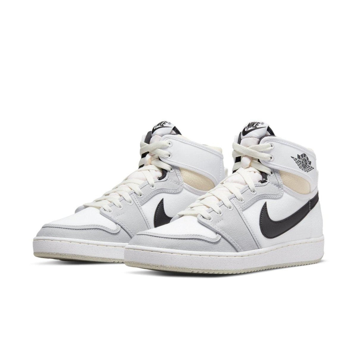 Jordan 1 Retro AJKO sneakers in white, black, and grey fog with Nike branding and cushioned sole for style and comfort.