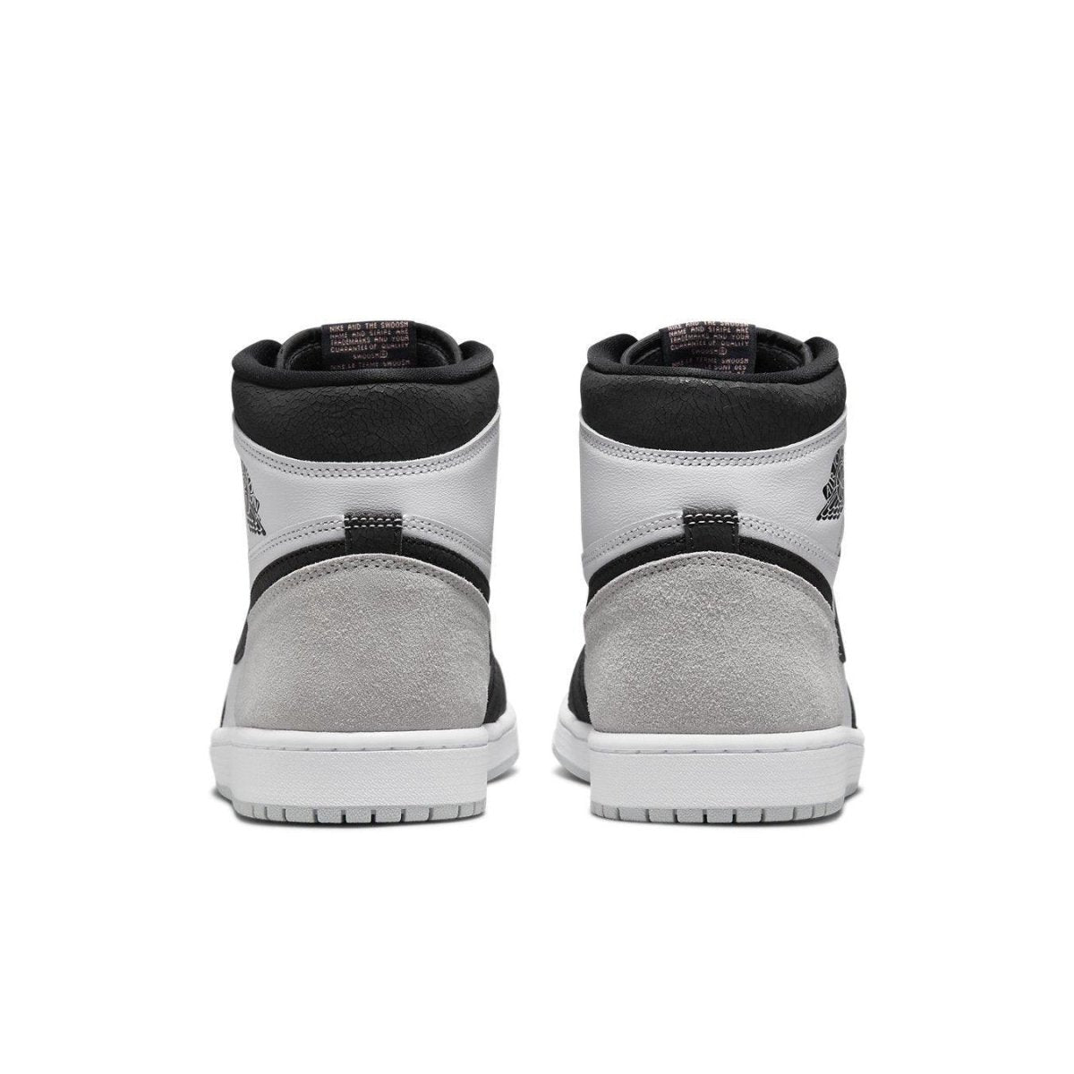 Rear view of Air Jordan 1 Retro High OG Stage Haze showcasing gray suede and black leather accents.