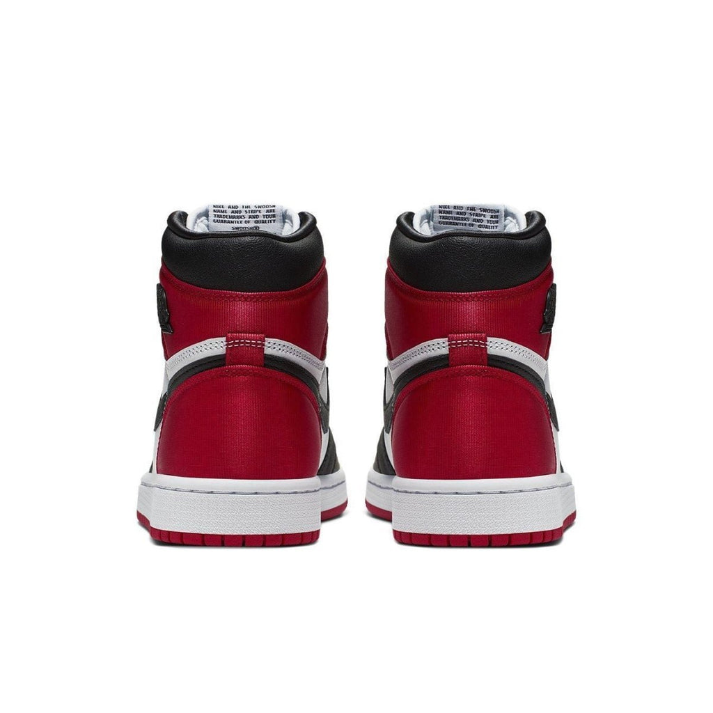 Back view of Air Jordan 1 Retro High Satin Black Toe women's sneakers featuring red satin panels.