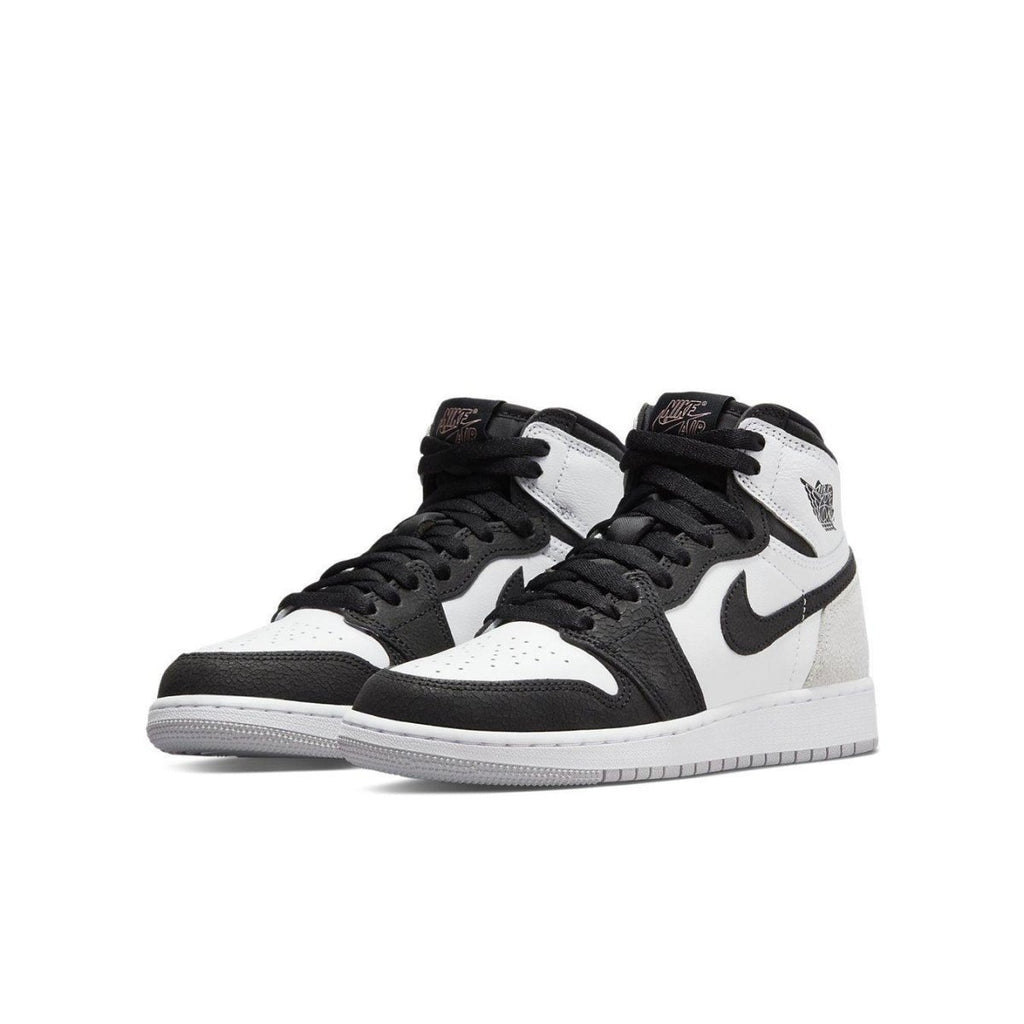 Air Jordan 1 Retro High Stage Haze (GS) in black, white, and grey with coral accents.
