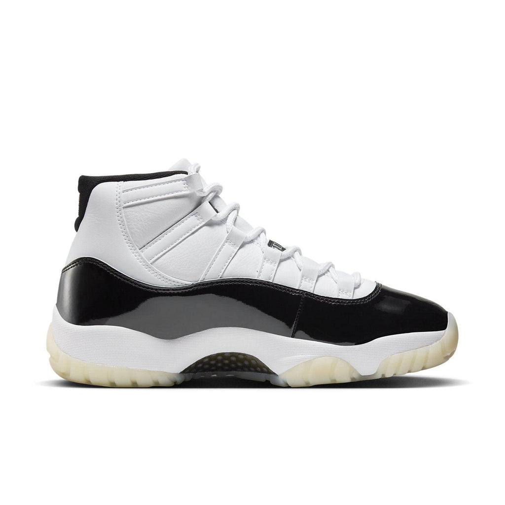 Side view of Air Jordan 11 Retro DMP Gratitude 2023 with white leather upper and black patent leather details.