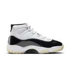 Side view of Air Jordan 11 Retro DMP Gratitude 2023 with white leather upper and black patent leather details.