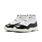 Air Jordan 11 Retro DMP Gratitude 2023 in white and black with a sleek patent leather finish.