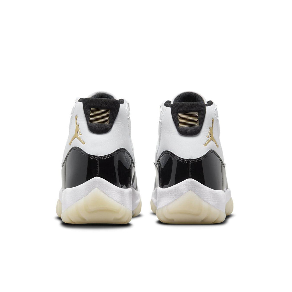 Jordan 11 Retro DMP Gratitude 2023 sneakers showcasing a sleek black and white design from the back view.