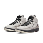A Ma Maniére x Air Jordan 2 Retro SP 'Airness' sneaker in light grey with burgundy accents and translucent heel.