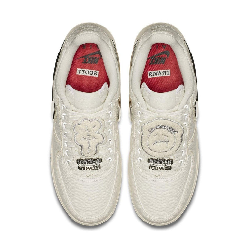 Nike Air Force 1 Low Travis Scott Sail sneakers with unique lace bling and red insoles featuring trademark logos.
