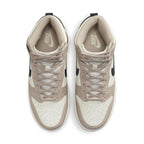 Nike Dunk High Fossil Stone women's sneakers with beige and ivory leather upper and black Swoosh.