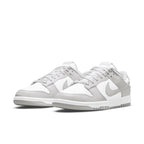Nike Dunk Low Grey Fog in white and light grey colorway, featuring sleek leather design and classic basketball silhouette.